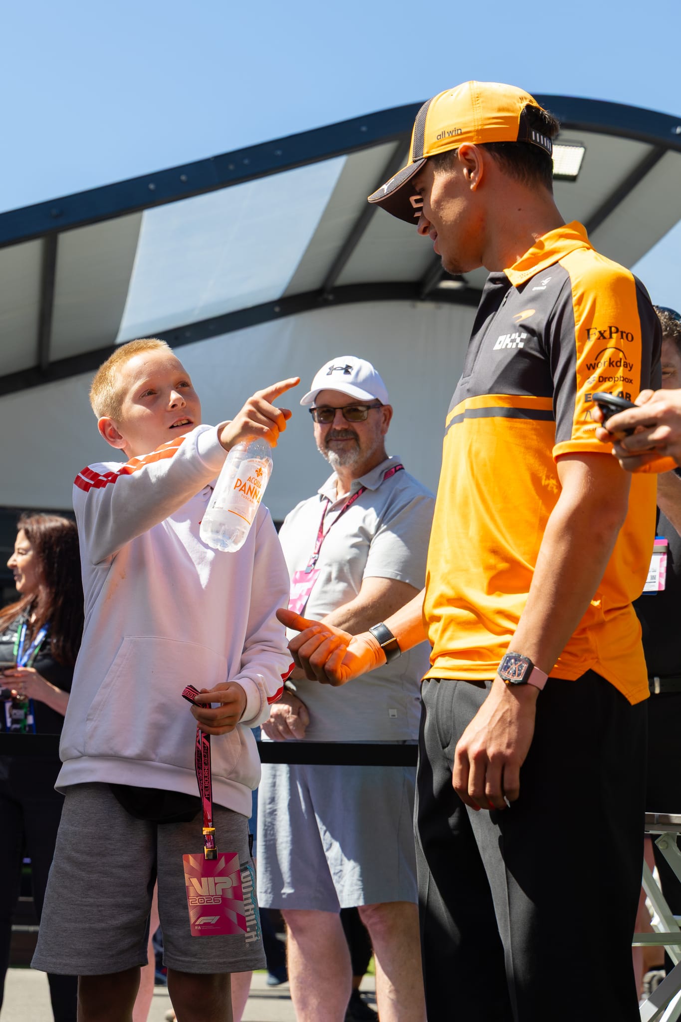 A young What Ability participant meeting a Formula 1 driver trackside