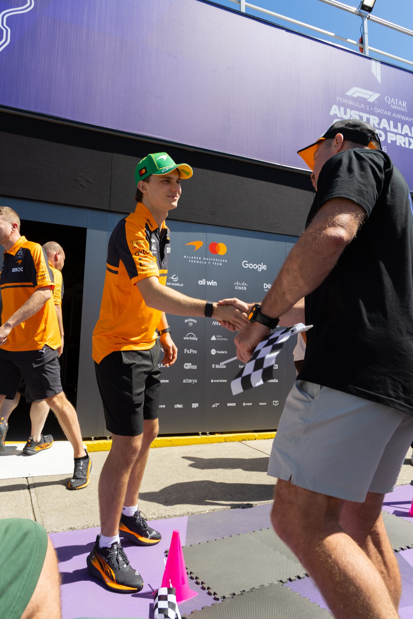 A What Ability participant shaking hands with a Formula 1 driver