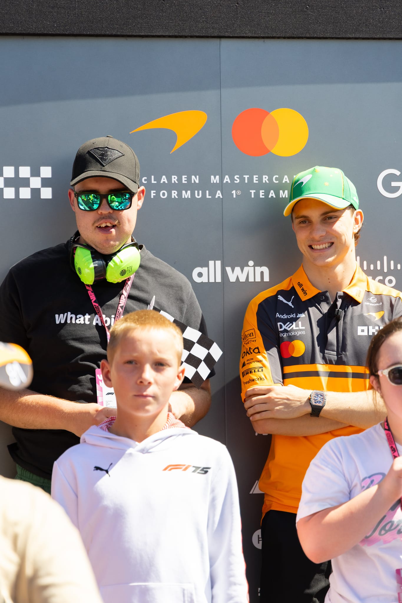 A What Ability team member with an F1 driver at the Australian Grand Prix