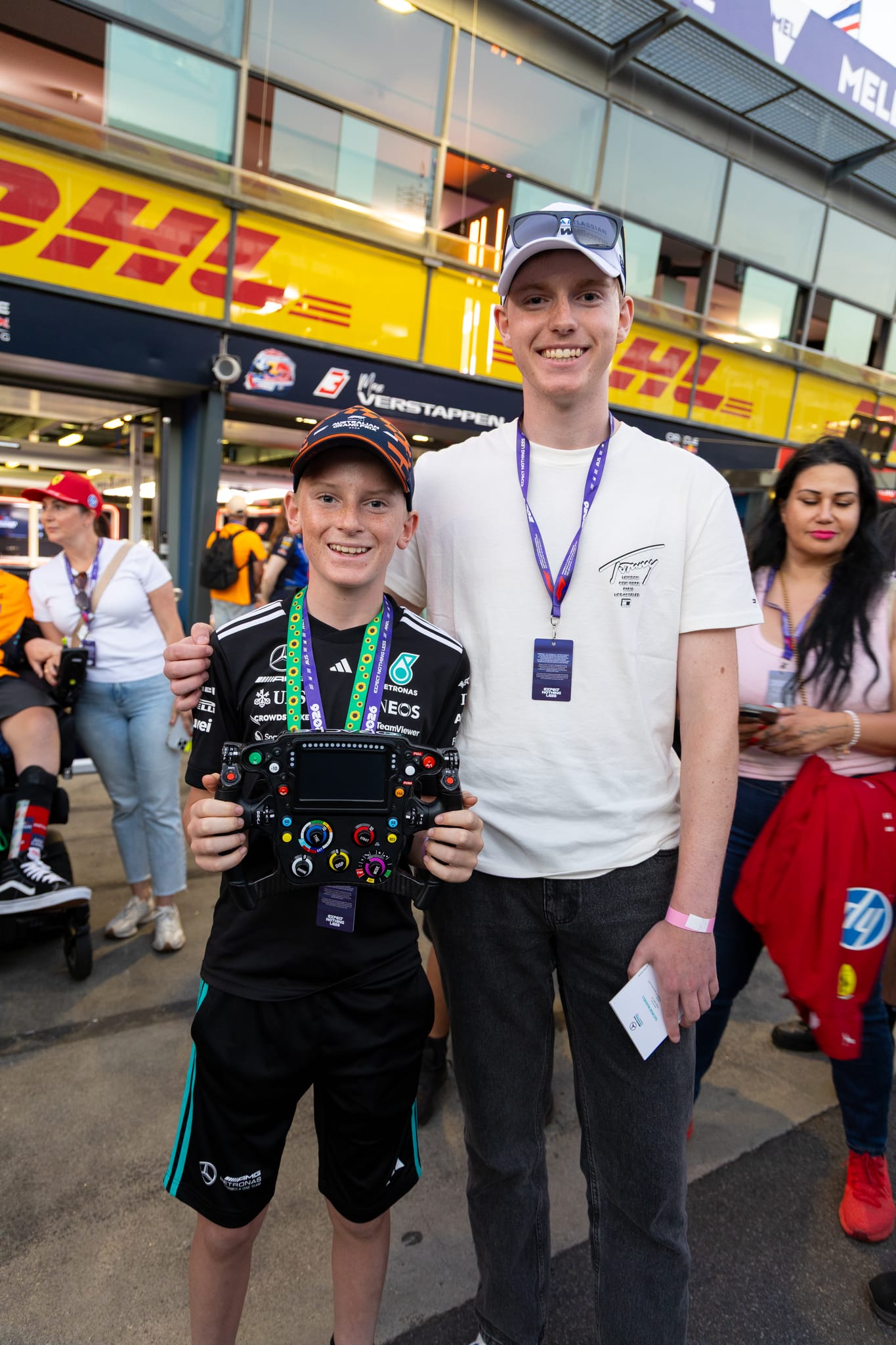 A What Ability participant holding a Formula 1 steering wheel