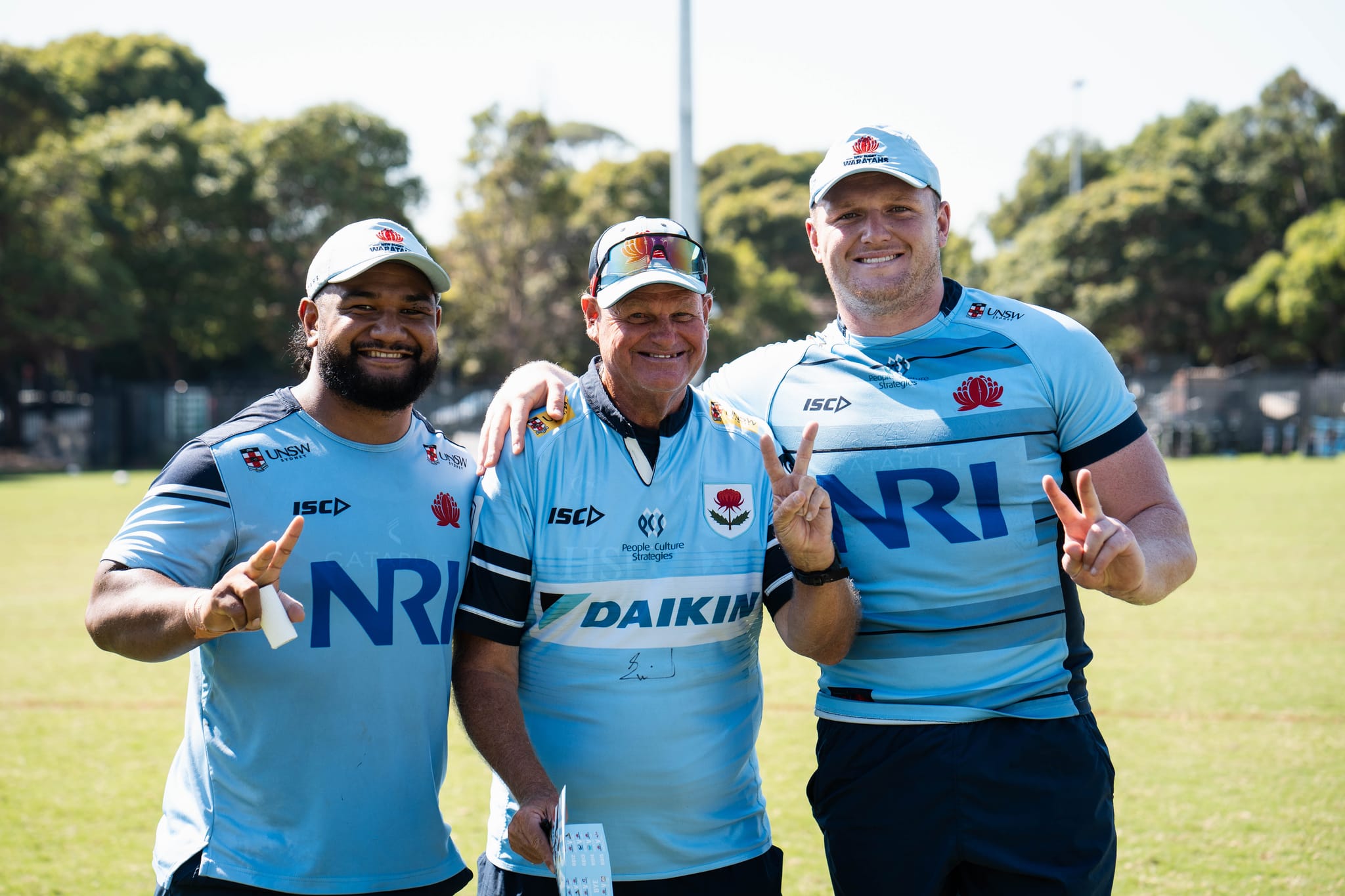 Participants on the field with NSW Waratahs rugby players